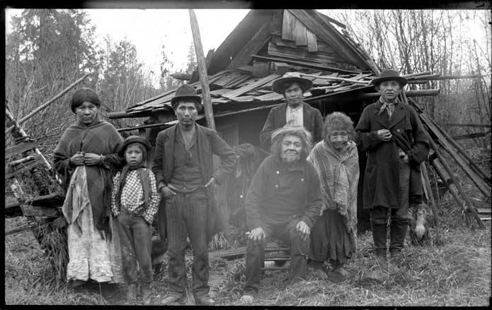 A group of Nooksack Natives gathered outside a house 