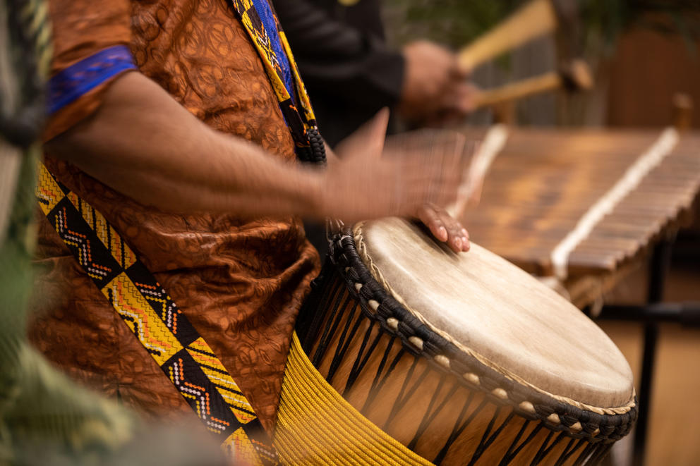 Close up of hands in motion pounding on a drum