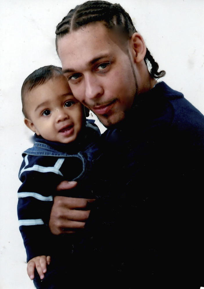 Leonard Thomas holding his son, Elijah