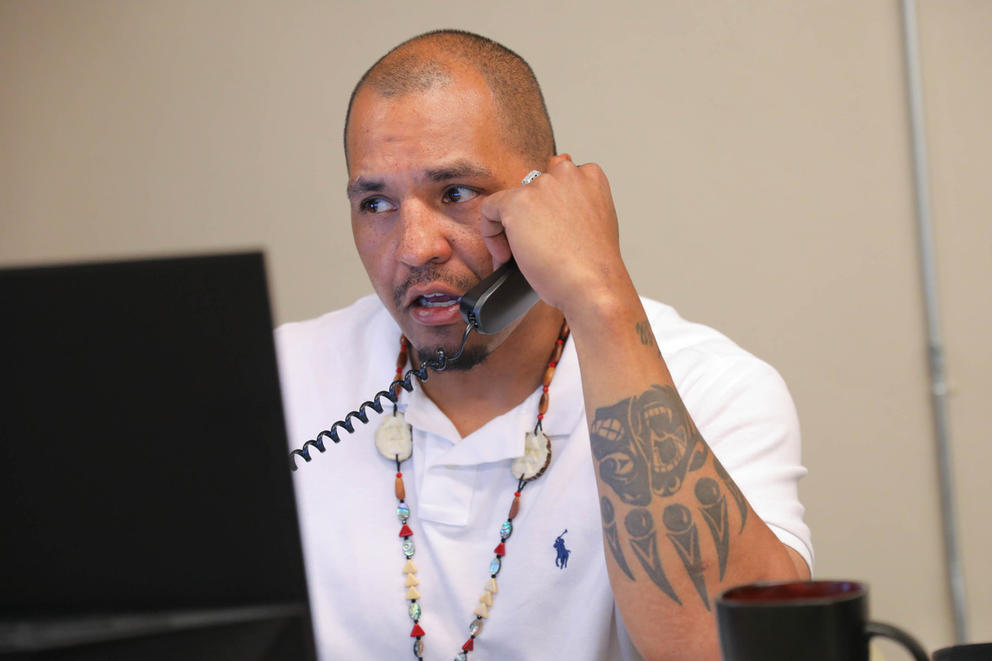Case manager Osceola Fortner (Winnebago Tribe) talks on the phone in the HEAL for Reentry offices