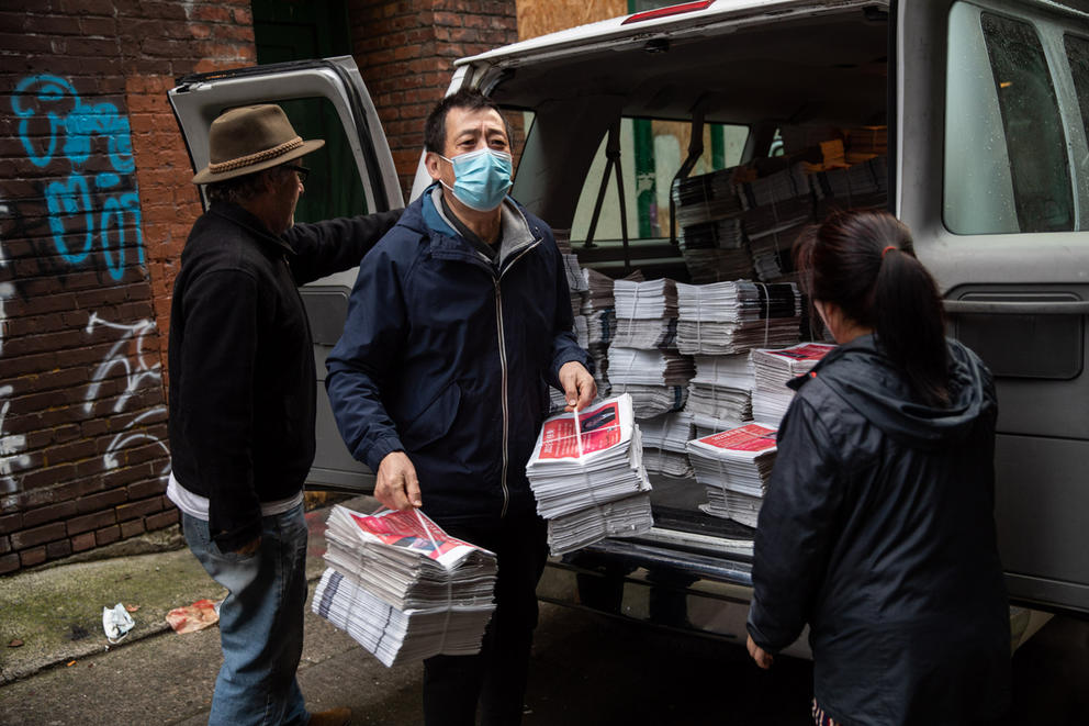 Volunteers load in the last print editions of Northwest Asian Weekly and Seattle Chinese Post papers