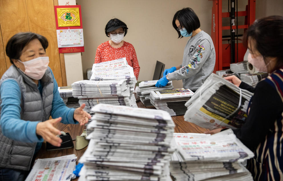 Nancy Chang, R. Chan, Yuxia Li and Ya Tong Hen prepare the last print edition for Northwest Asian Weekly and Seattle Chinese Post papers