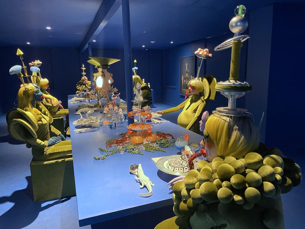 an elaborate dining room scene featuring humanoid aliens in outlandish costumes
