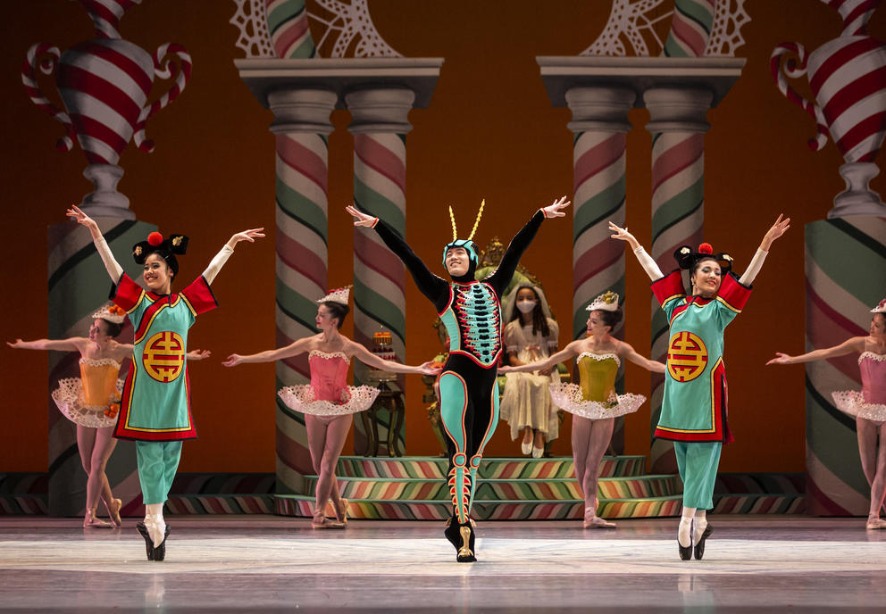 photo of three ballet dancers on stage in green costumes