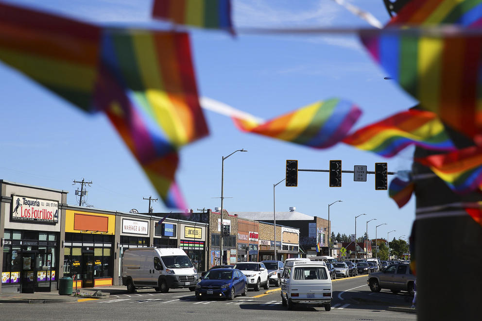Rainbow flags hang above 16th Avenue SW