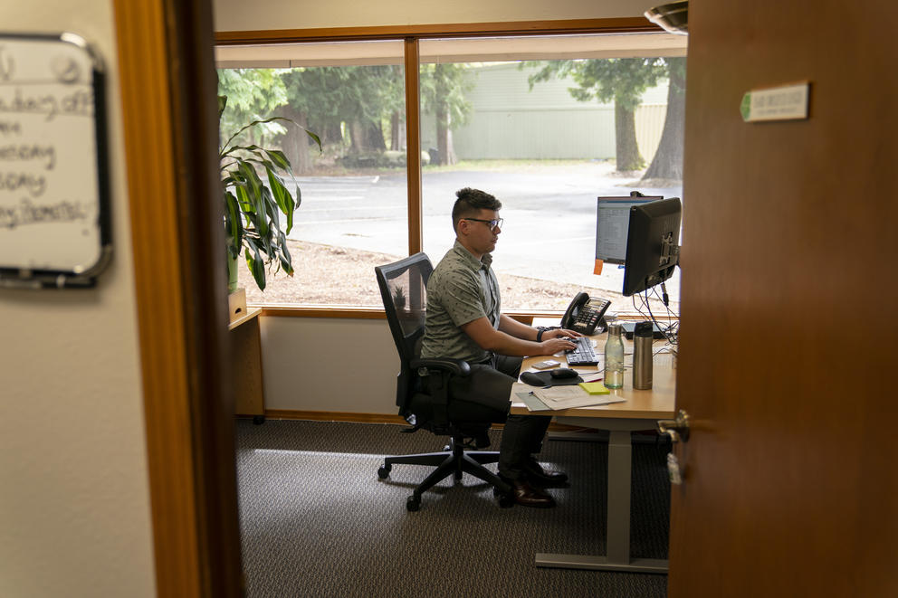 An eviction mediator works in his office.