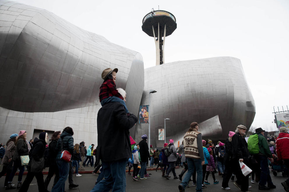 Demonstrators walk past the Museum of Pop Culture and the Space Needle, reaching the end of Seattle Women’s March 2.0 at Seattle Center in Seattle, Jan. 20, 2018.