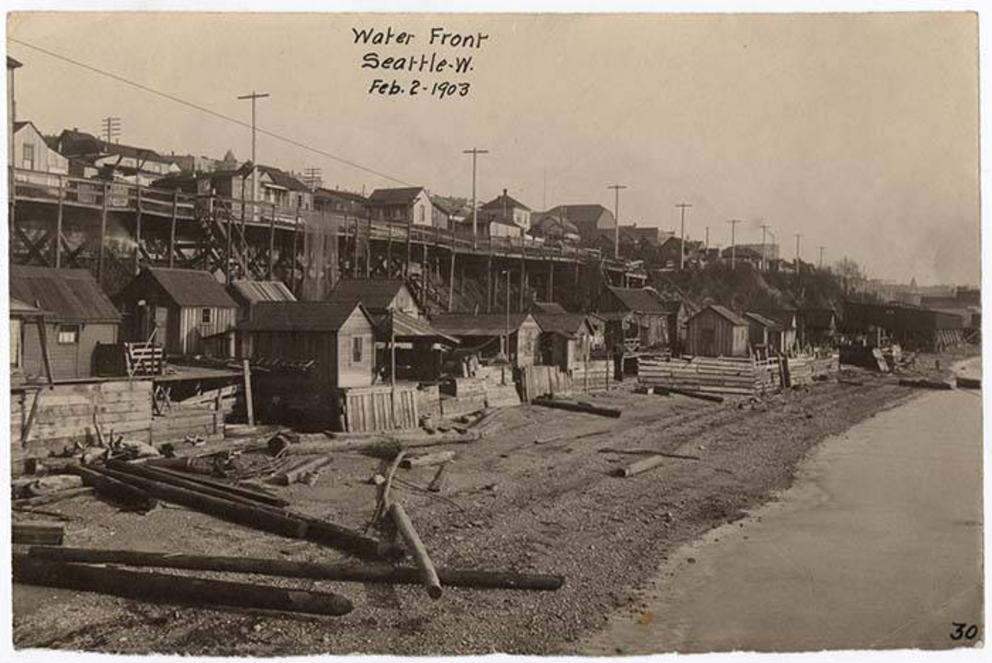 black and white image of shacks on a beach in Seattle