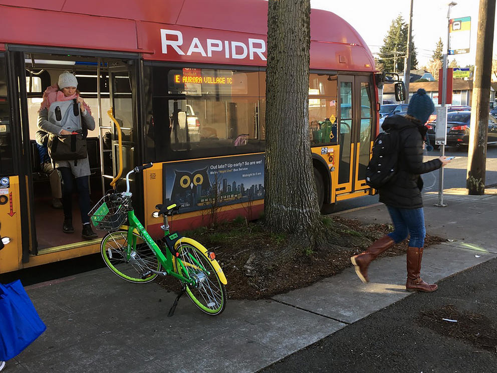 A rental bike directly interferes with a transit rider as she turns into a pedestrian (Photo by Douglas MacDonald)