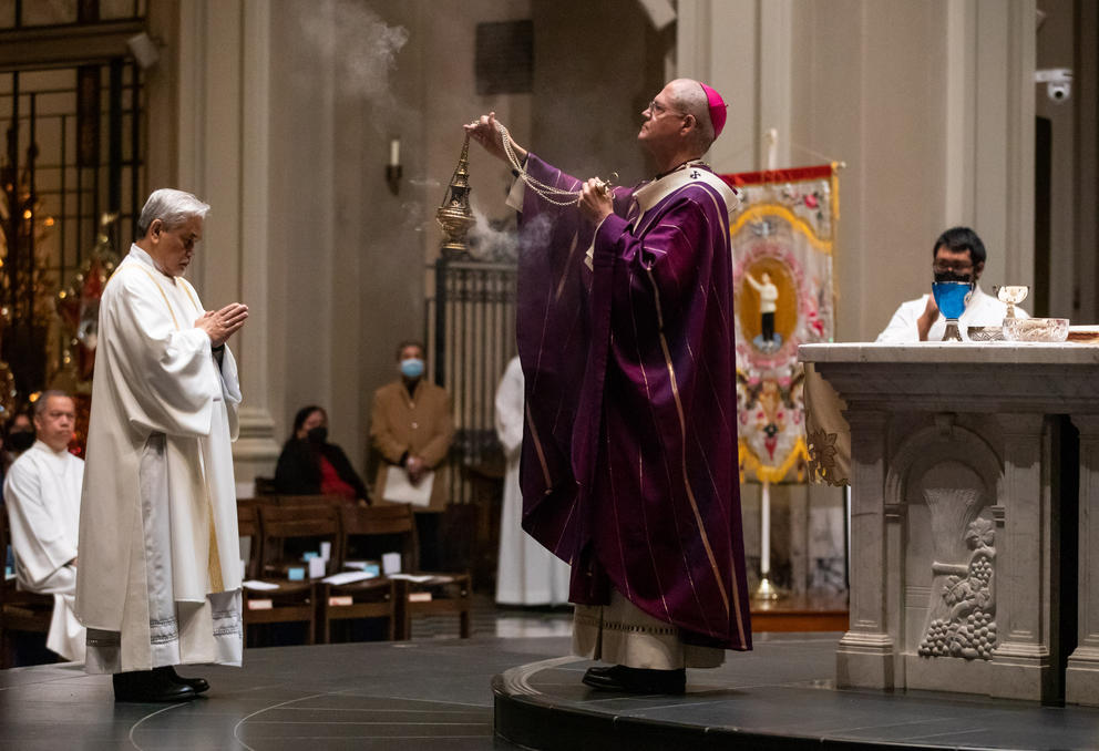 Seattle Archbishop Paul D. Etienne spreads the smoke of the thurible during the conclusion of the mass.