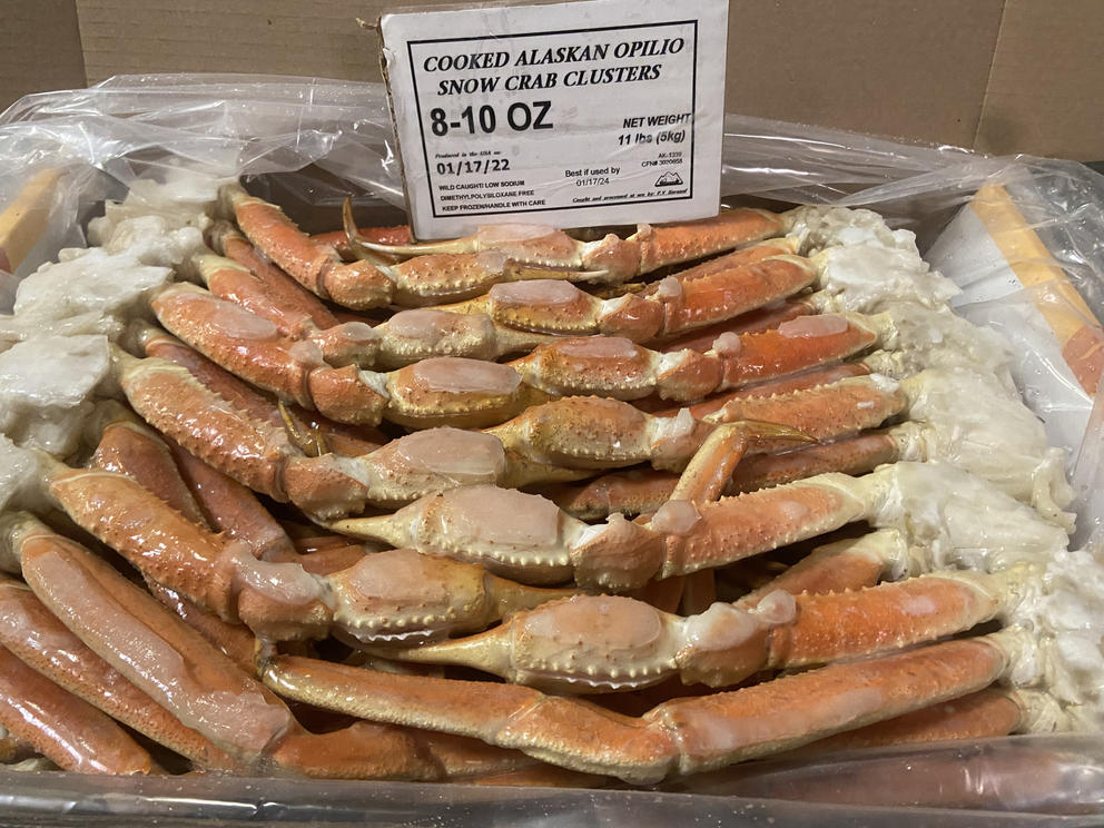Frozen crabs in a bin for sale