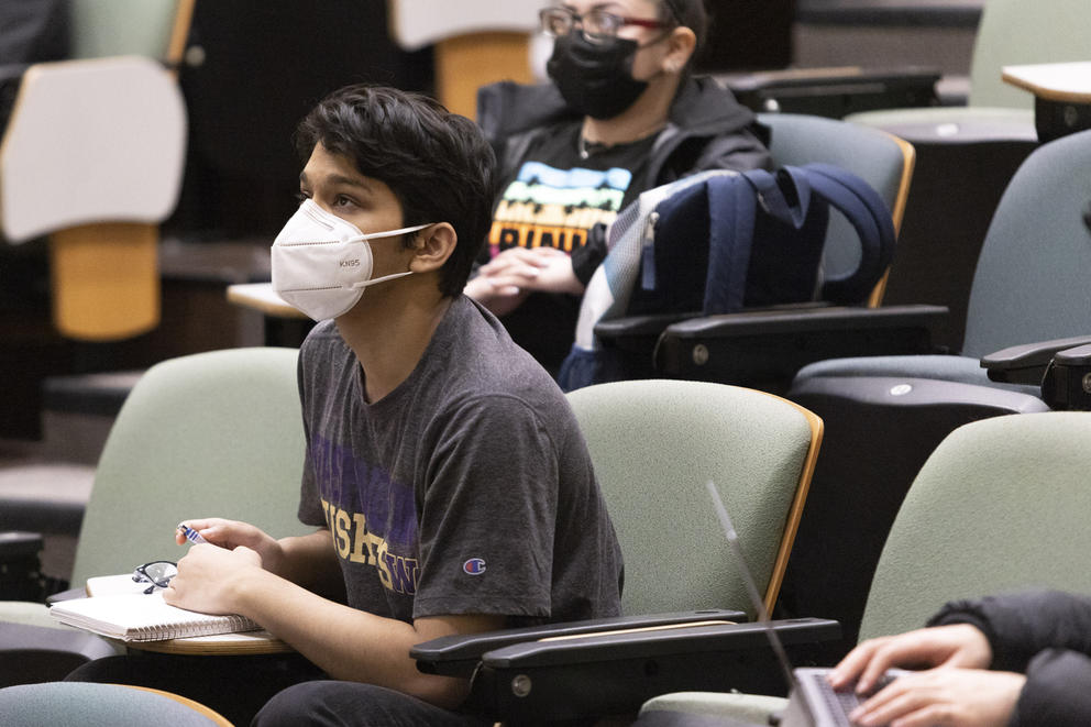A student wearing a face mask while sitting at a desk