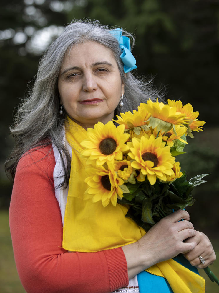  Irina VanPatten is adorned with a special Moldovan hand towel and colors of the Ukrainian flag while holding decorative sunflowers