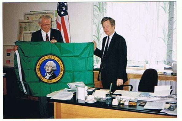 Two men holding Washington state flag 