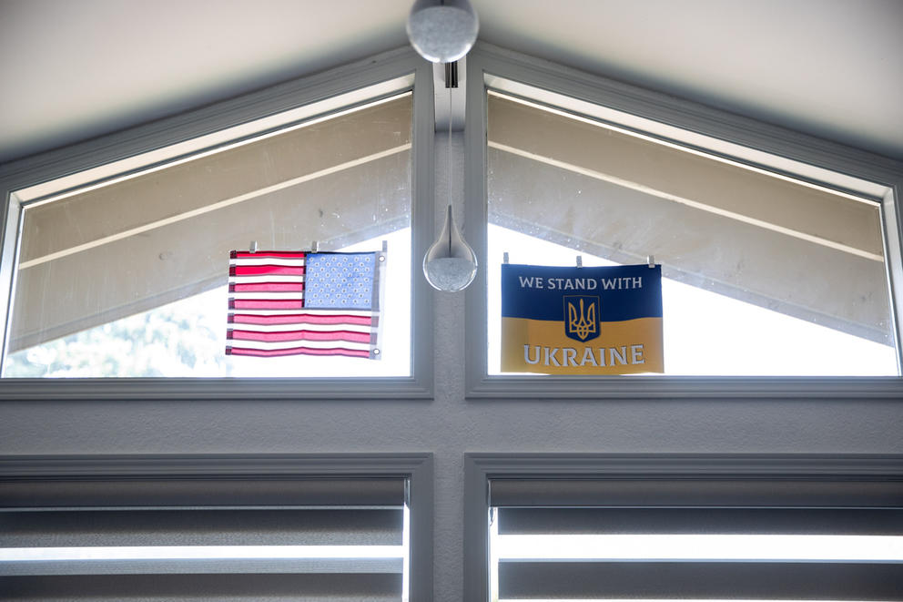 Irina and John VanPatten hang a Ukrainian flag in their home.