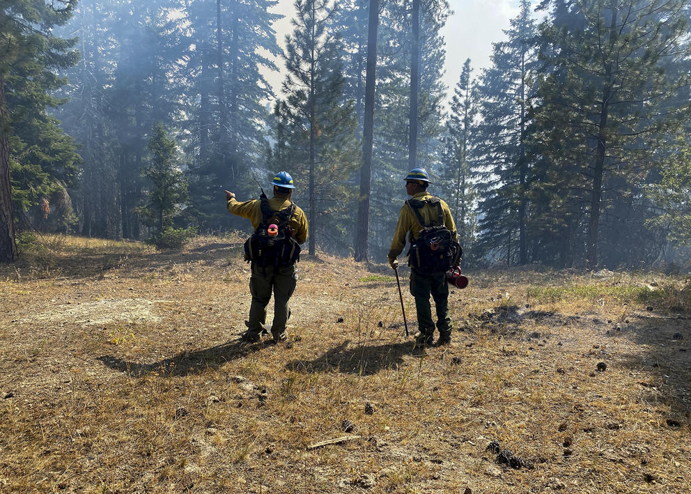 two firefighters standing next to each other