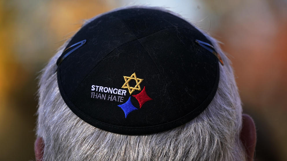 A yarmulke on a man’s head, featuring a Star of David and the words ‘stronger than hate’