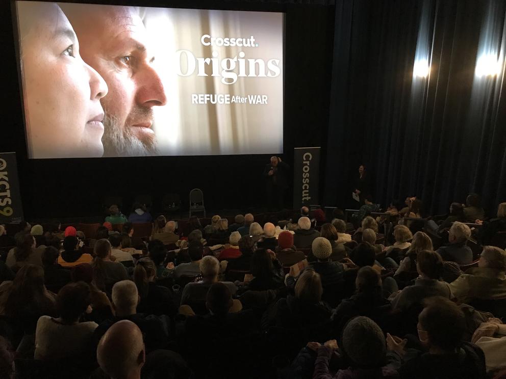 A crowd shot of a full theatre viewing the Crosscut Origins: Refuge After War premiere. 