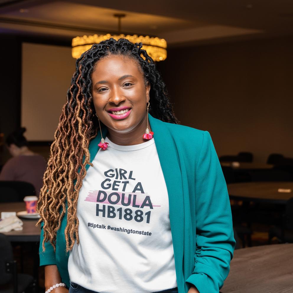 Stephaine Courtney, the founder of Shades of Motherhood in Spokane, with a shirt that reads "GIRL GET A DOULA HB 1881" (Courtesy of Stephaine Courtney)