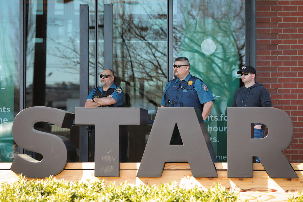 Security guards stand outside Starbucks