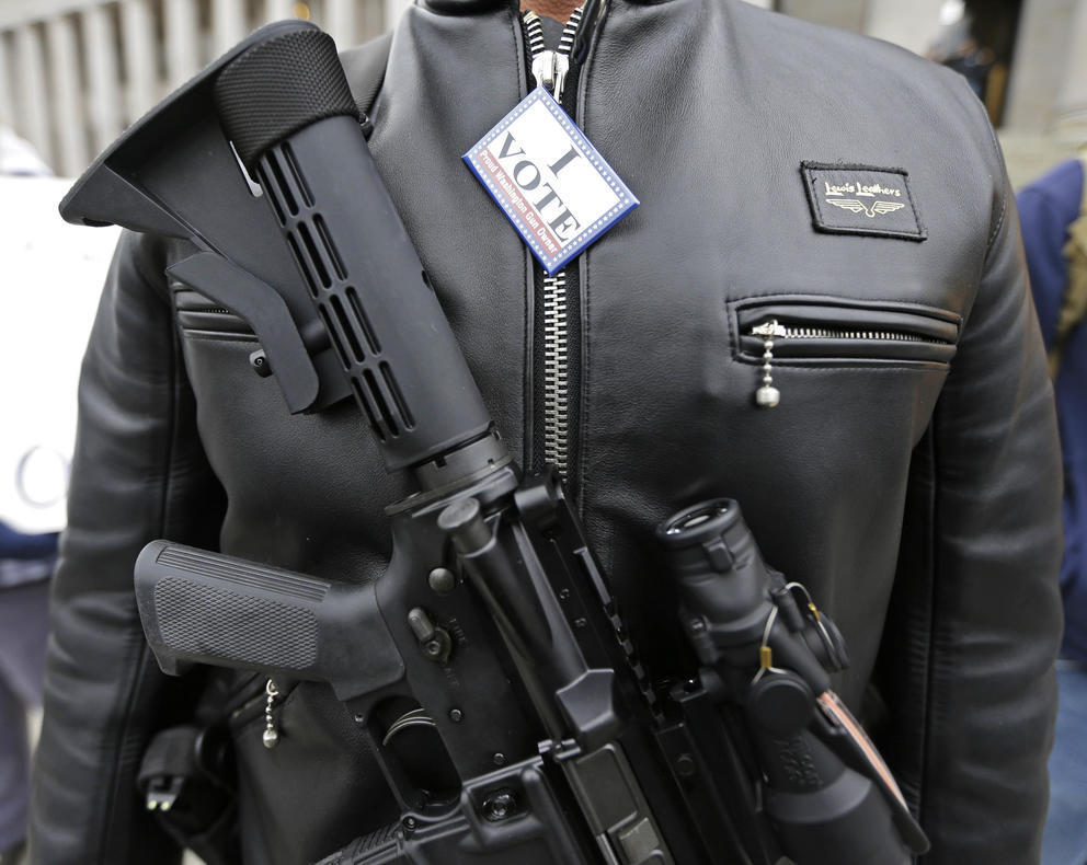 gun wearing man at a protest