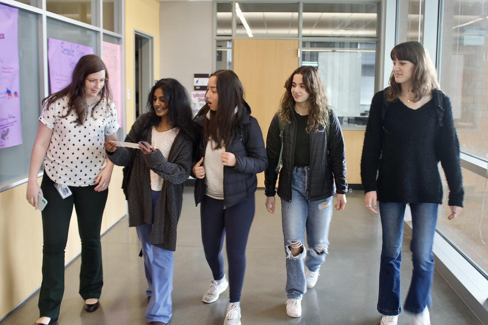 Teacher Bethany Shoda walks with her students, from left, Mahee Nemani, Gabrielle Heuer, Ana Ferreira, and Abigail Jalso