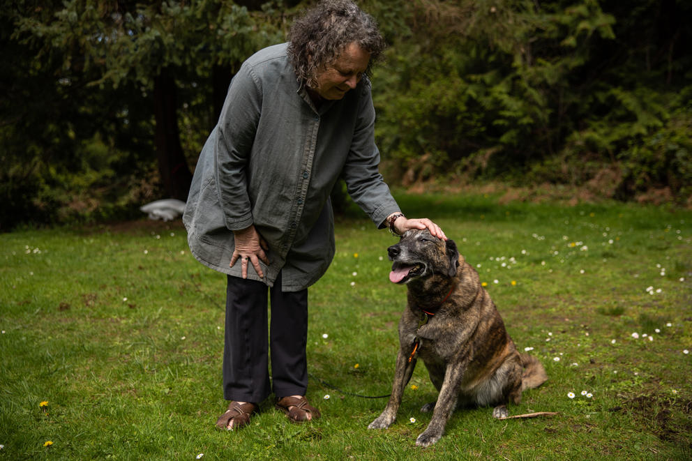 Marni Gustavson with her dog, outside their home in Port Orchard