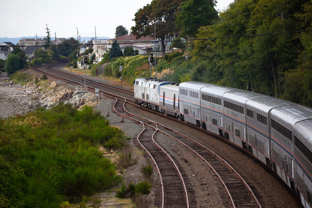 The Amtrak Empire Builder heads north on a track winding through Richmond Beach