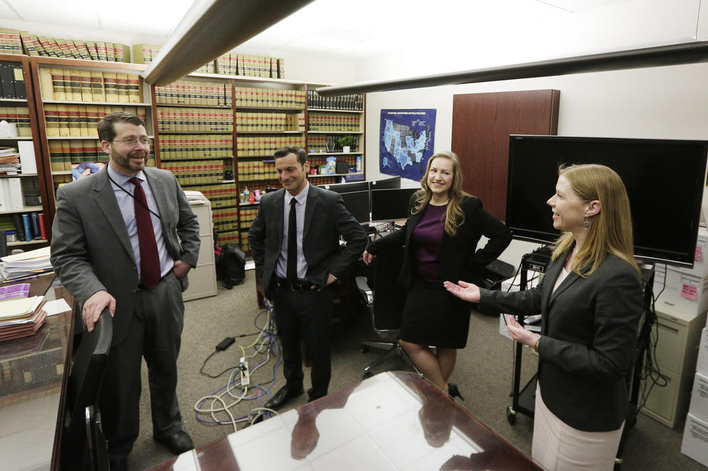 Four prosecutors with the U.S. Attorney's Office stand in their office in Spokane