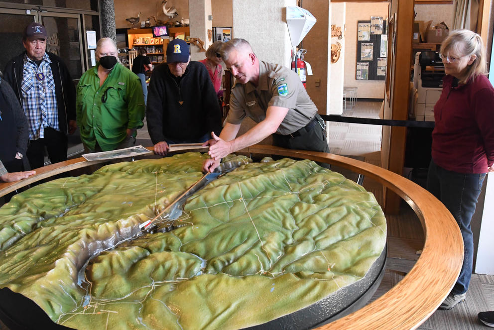 Washington Interpretive Park Ranger David McWalter uses a 3-D model at the Dry Falls Visitor Center to explain how cataclysmic ice age floods carved out Grand Coulee, Dry Falls and the other coulees