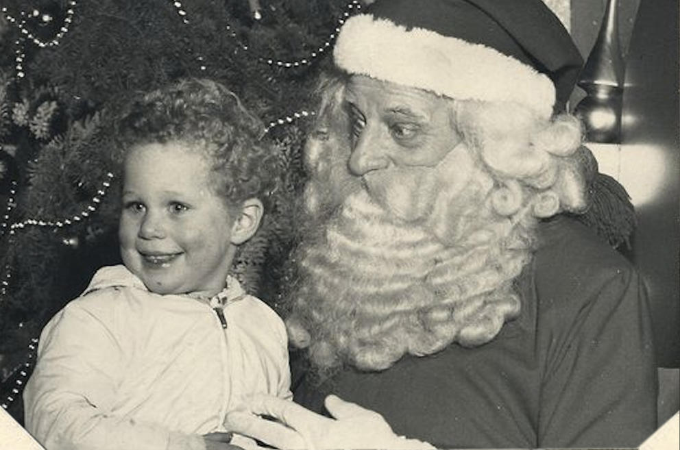Archival photo of a boy sitting on Santa’s lap