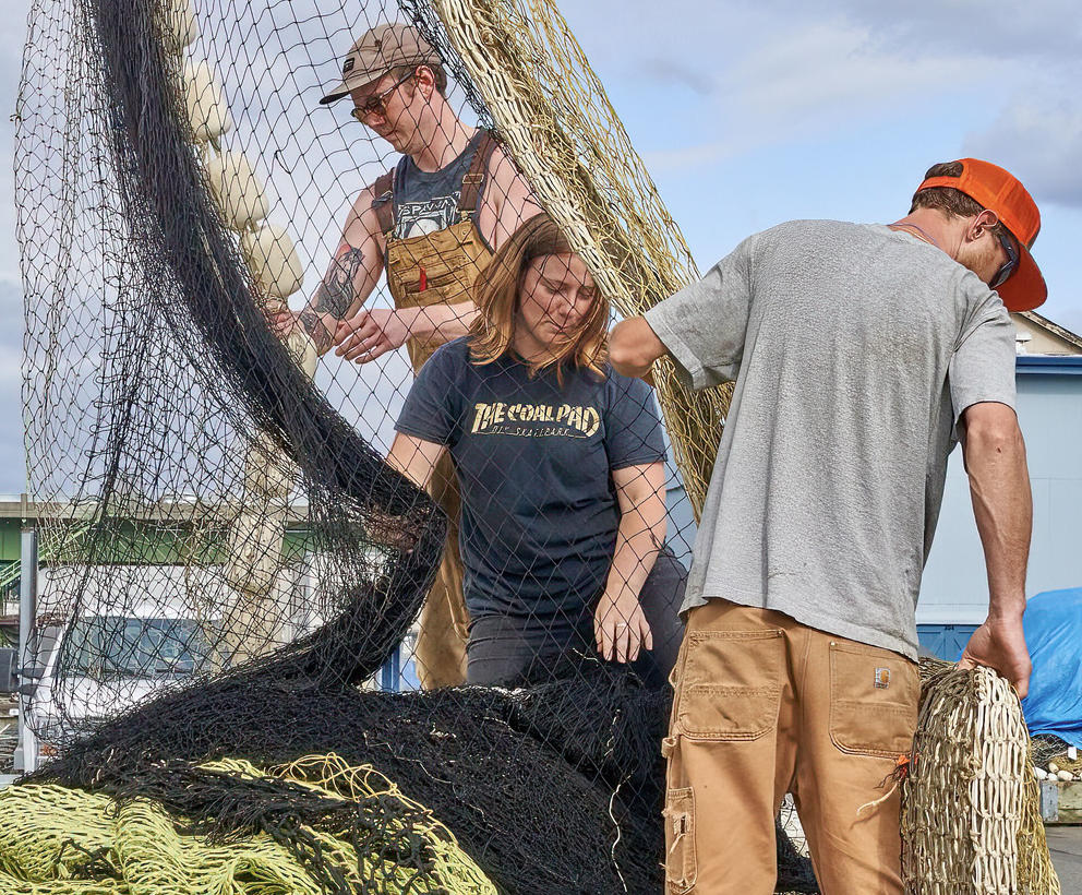 Brigett Cronk pitches in stacking the nets for the FV Wonderland trip to Alaska.  ‌