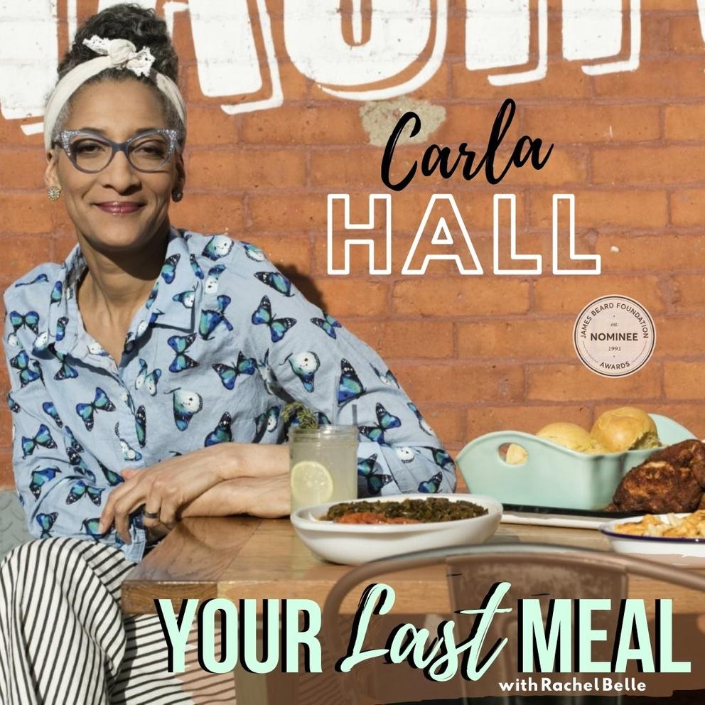 carla hall in front of a brick wall