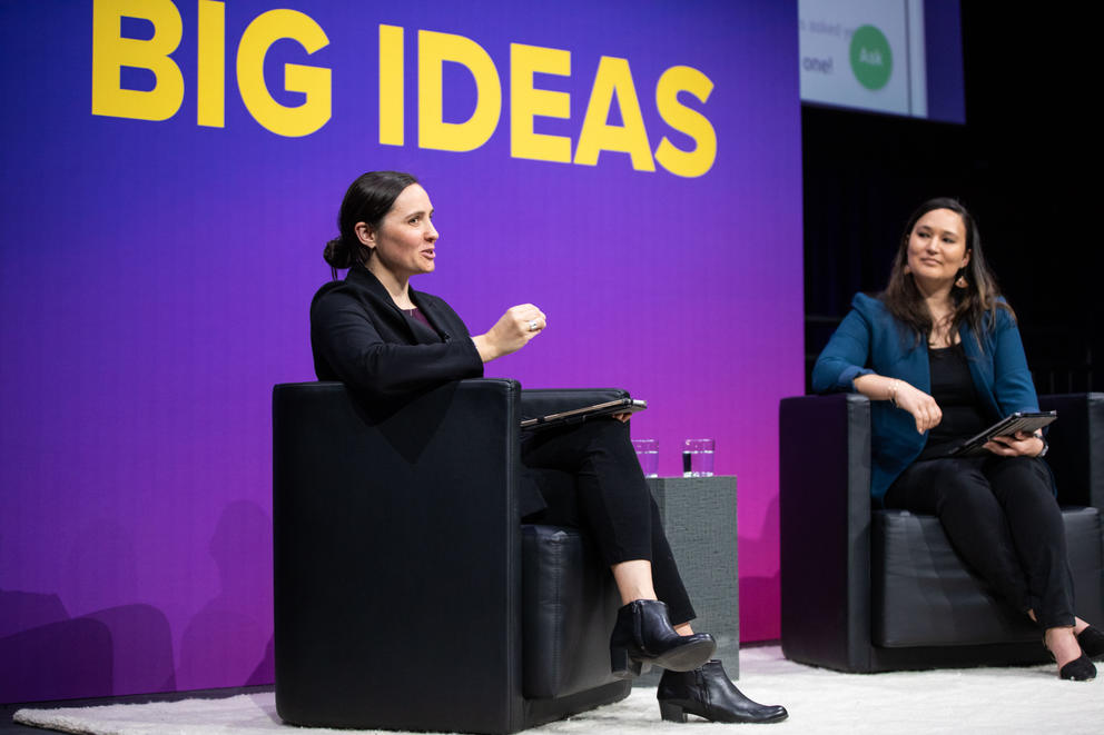 Two people sitting on stage under the words “BIG IDEAS”