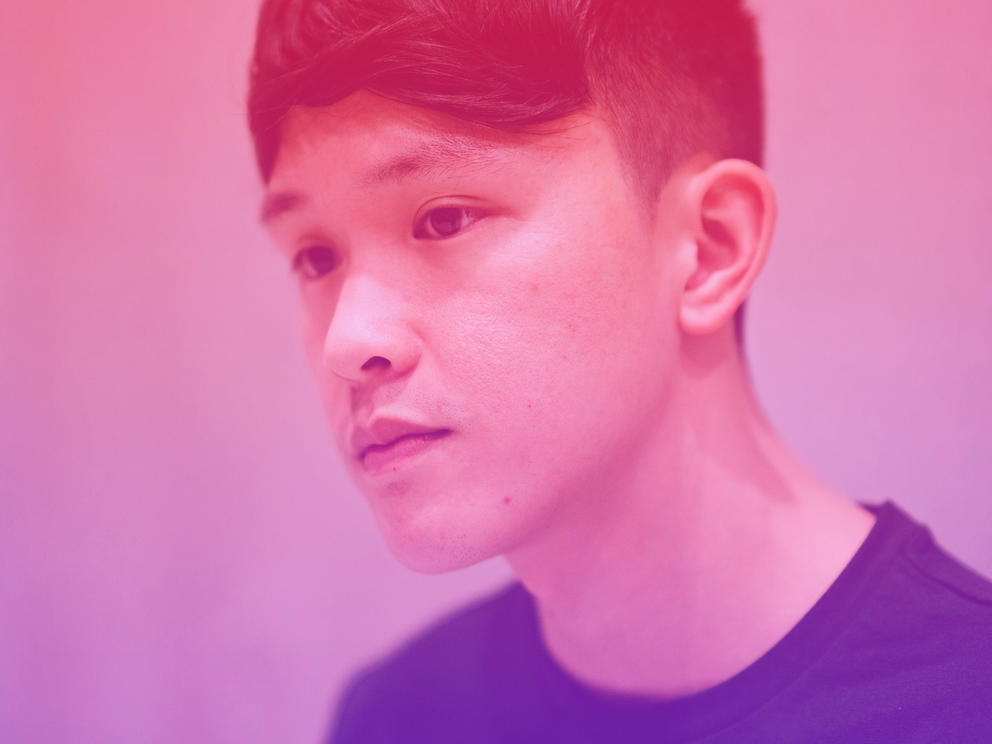 A red, purple and pink color gradient on a photo of a man looking into the distance