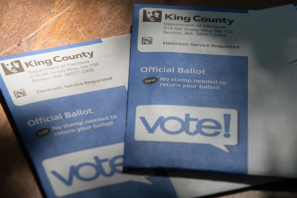 Two King County ballots on a table in their envelopes.
