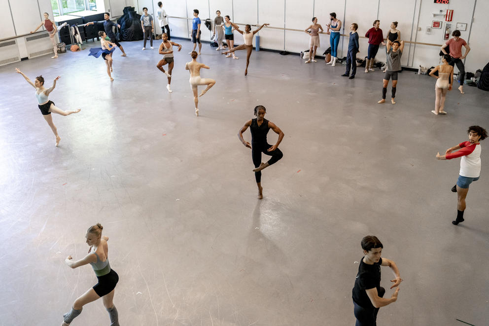 A wide shot of dancers dancing in a studio