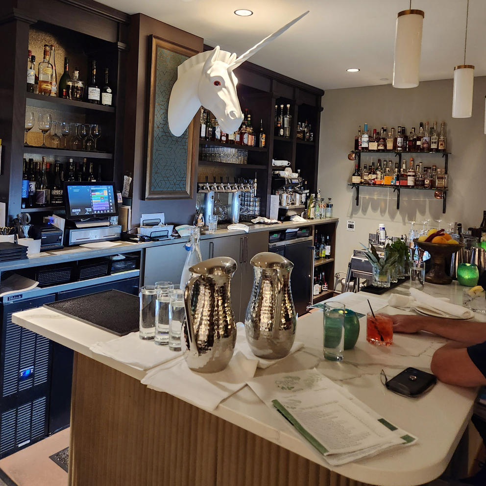 A unicorn watches over the Tonsorium Bar inside The Lodge at St. Edward Park 