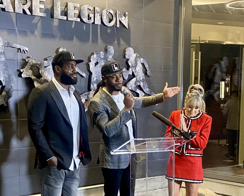 Former Seattle Seahawks players Kam Chancellor and Richard Sherman stand in front of the restaurant Legion they are opening in Bellevue with business partner Leilani Wong.