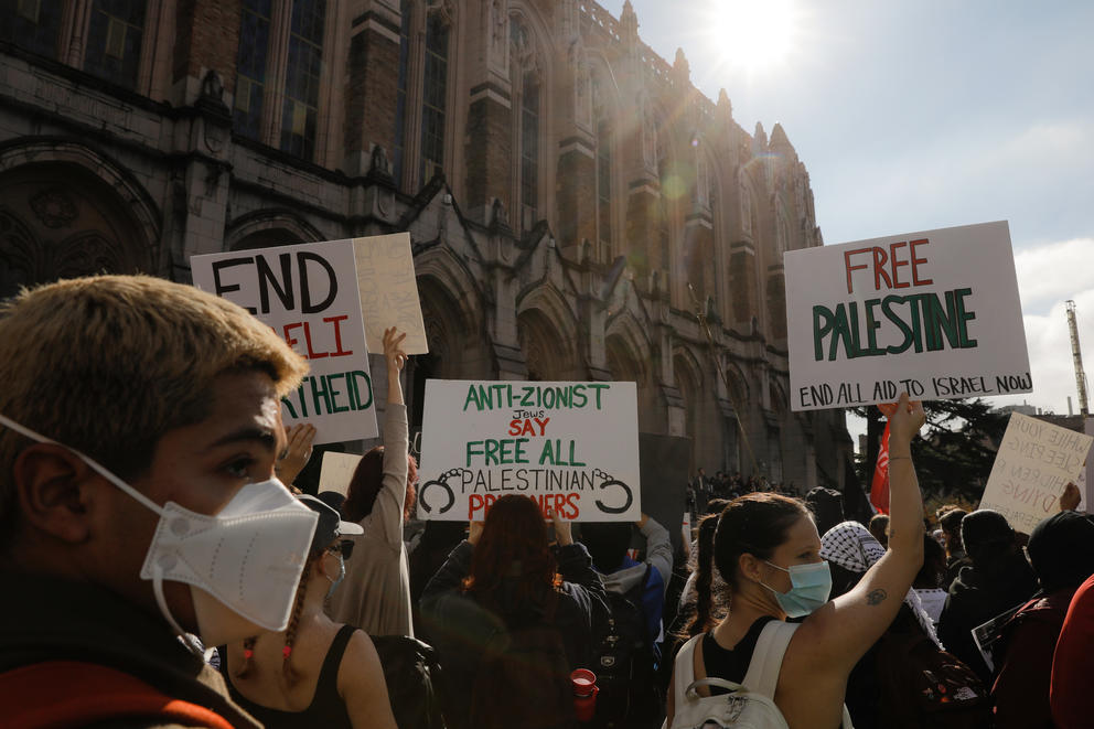 Students hold pro-Palestinian signs at a rally