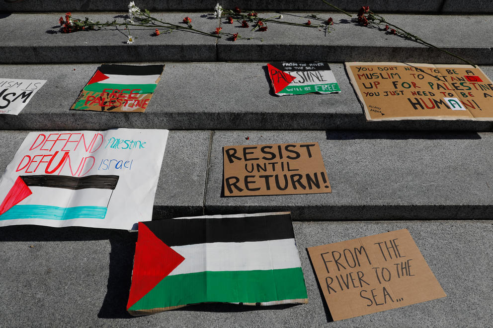 Pro-palestinian signs are laid on the steps of Suzzallo Library