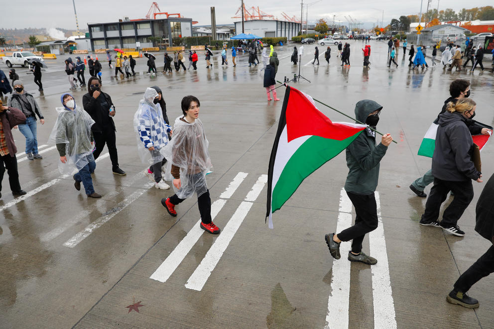 protesters walk around at the Port of Tacoma