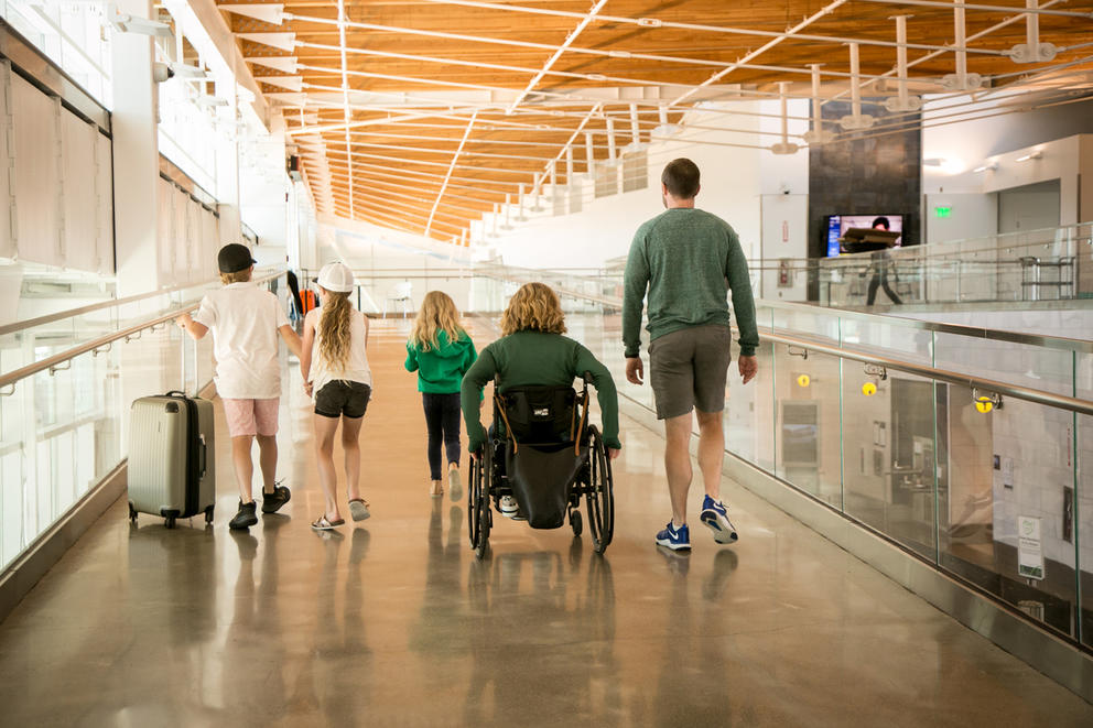 A family walks through the SeaTac airport