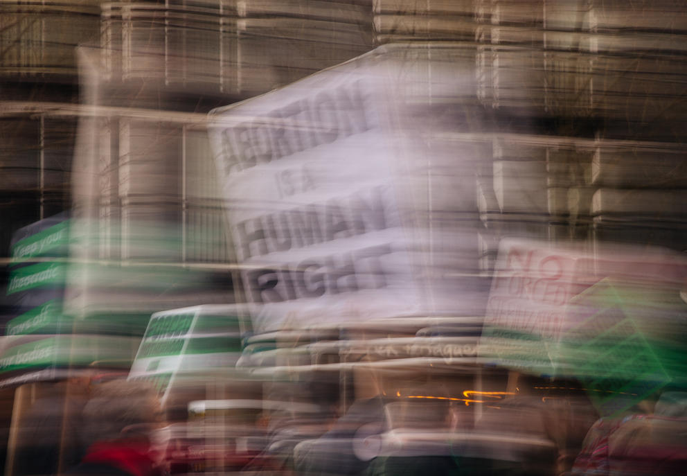 A motion blurred photo of signs during an abortion rights rally