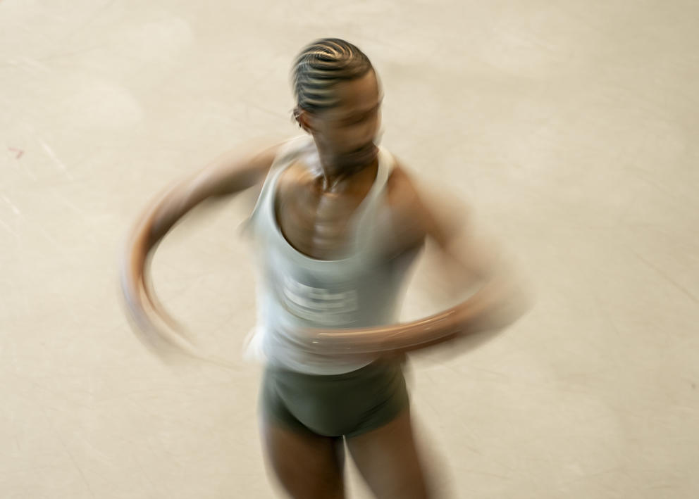 A ballet dancer blurs as he spins around, photographed from above