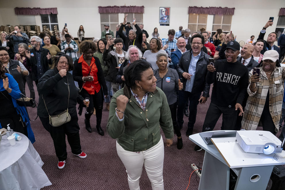 Joy Hollingsworth dances with a crowd of people at an election party