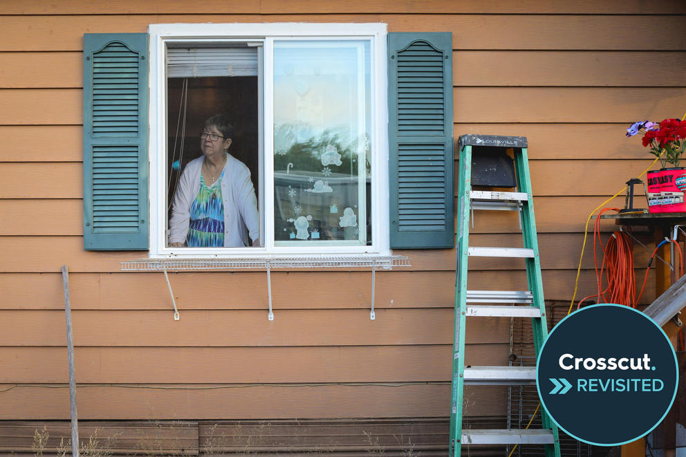 A woman looks out the window of her mobile home in Aberdeen.