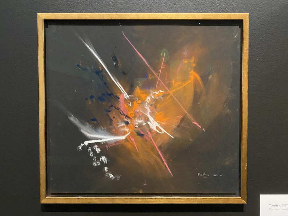 an abstract painting featuring an explosion of orange and white on a black backgound 