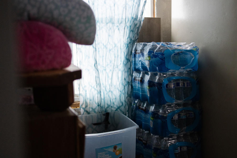 Four stacks of bottled waters line the wall of one home in Moxie Community.