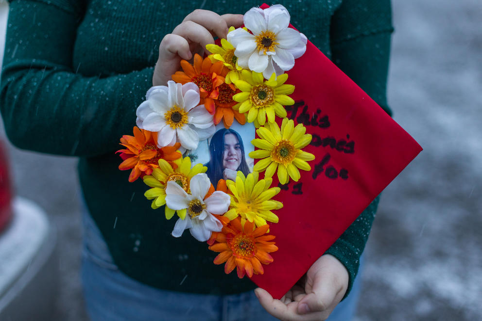 Amythist McCart shows her high school graduation cap adorned with a photo of her friend, missing teenager Kit Mora